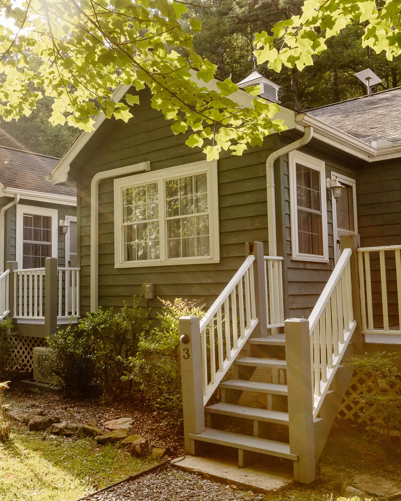 Porch steps up to a suite at Blue Boar Inn, the row of suites continuing beyond