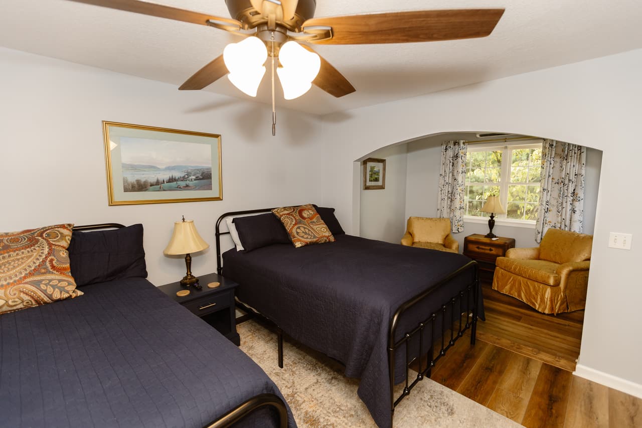 The Hideaway Suite, two queen beds and the sitting area through an arch